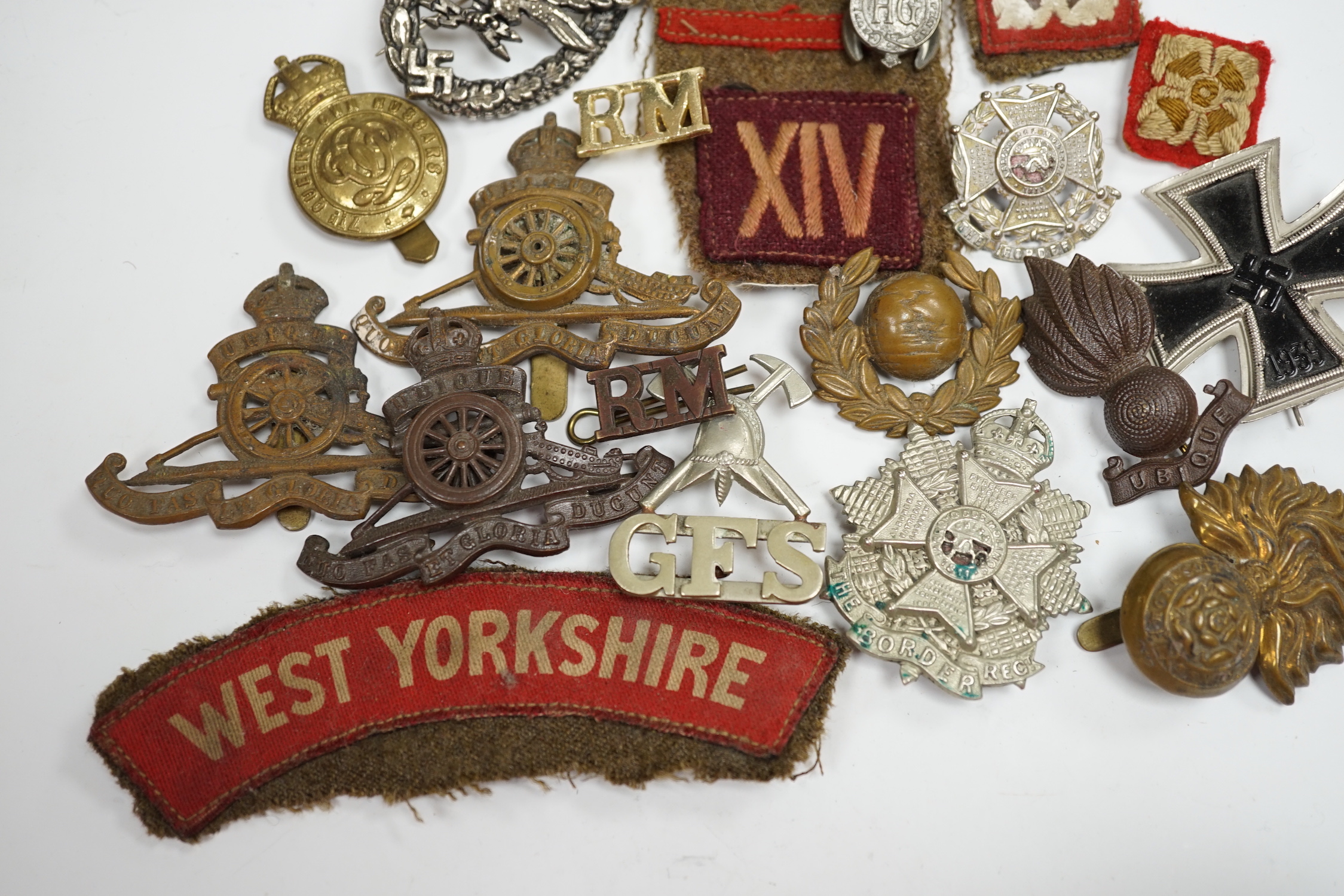 Three books on The Coldstream Guards 1914-18, Ross of Bladensburg, vols I and II and maps, together with a collection of cap badges, cloth shoulder titles, etc.